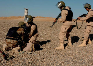 Officers from the 3rd Public Order Battalion detainee practice detaining techniques during a training exercise at
                                    Forward Operating Base Seven in December. The officers were preparing to take over policing duties in the city of Samarra
                                    at the end of the month. They were being trained by military and civilian officials, including George Clark, an international
                                    police officer and Philadelphia resident who played the role of the detainee. (Photo by Spc. Ismail Turay Jr., 196th MPAD)